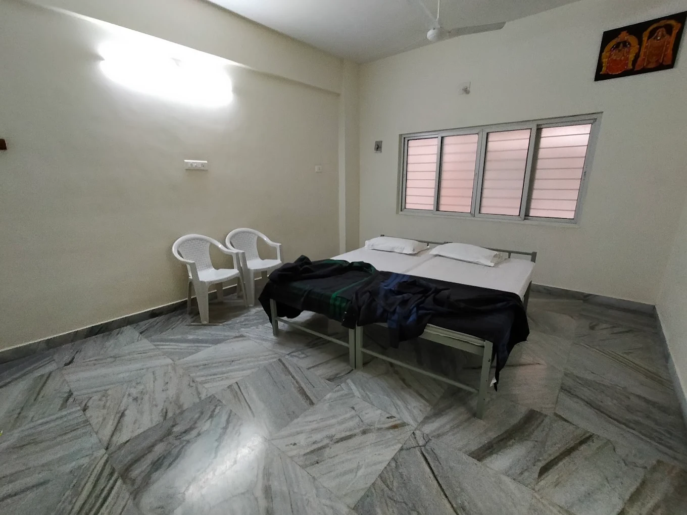 Room interior with double bed in Tirumala
